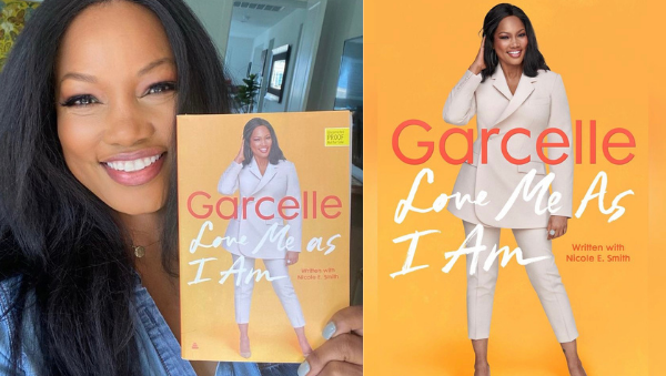 Garcelle Beauvais holding up her new book